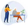 Une femme accompagnant une autre femme dans l'utilisation de son ordinateur, représentant le service d'assistance informatique à domicile.